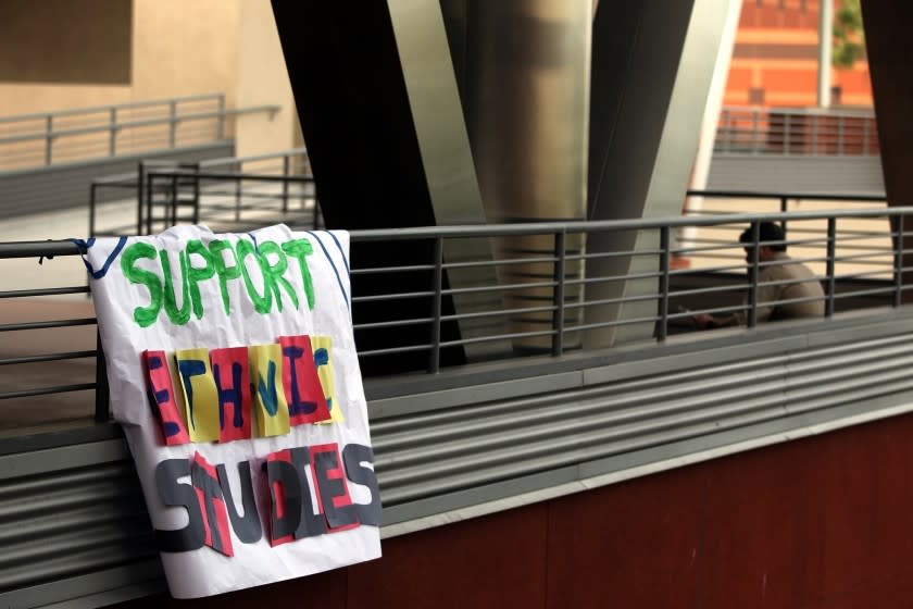 A banner hangs from an upper-floor railing as students demonstrate at Cal State L.A. in support of the ethnic studies programs.