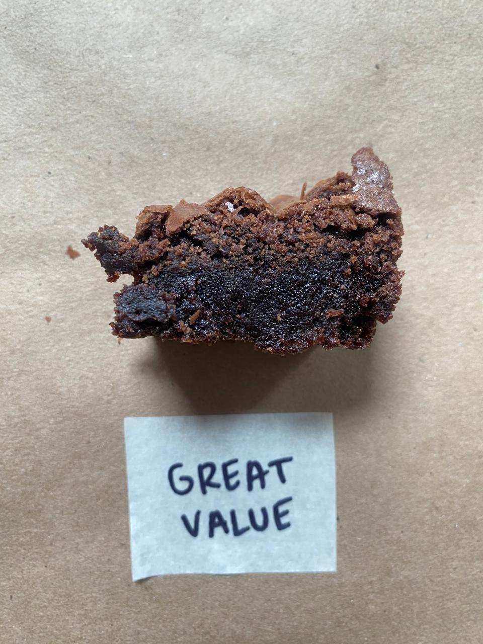 Piece of chocolate brownie above a label reading 