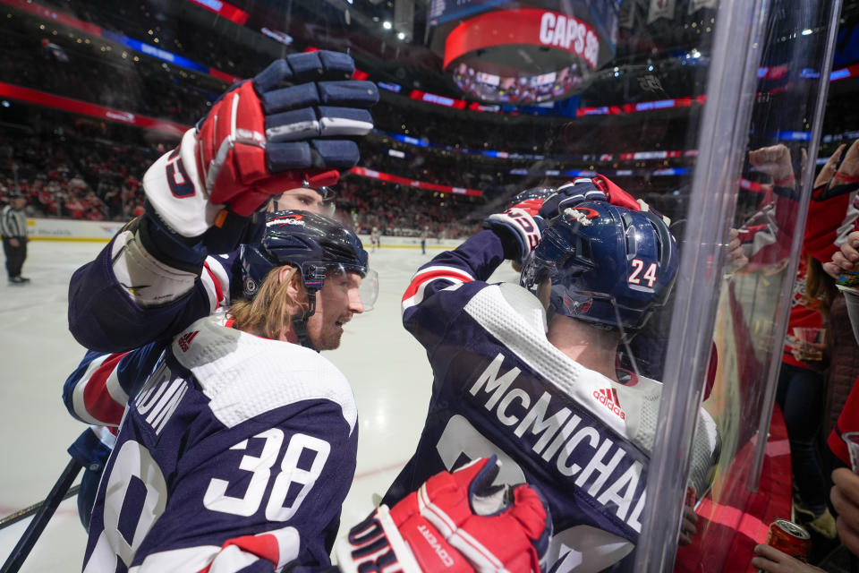 Washington Capitals center Connor McMichael celebrates his goal against the New Jersey Devils with teammates during the first period of an NHL hockey game Tuesday, Feb. 20, 2024, in Washington. (AP Photo/Alex Brandon)