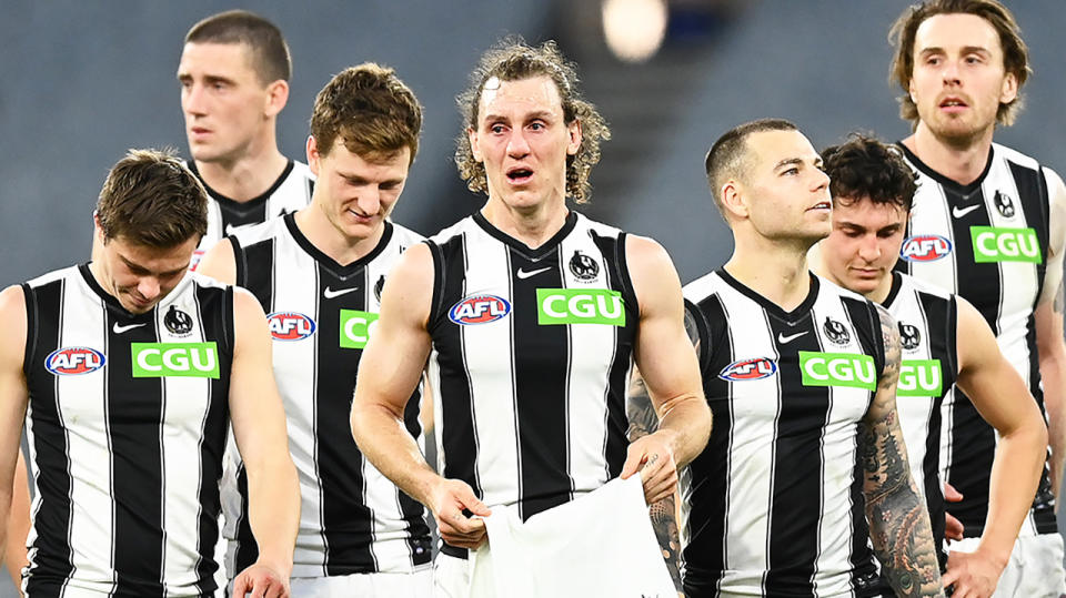 Collingwood walk off the field after their final AFL match of 2021.