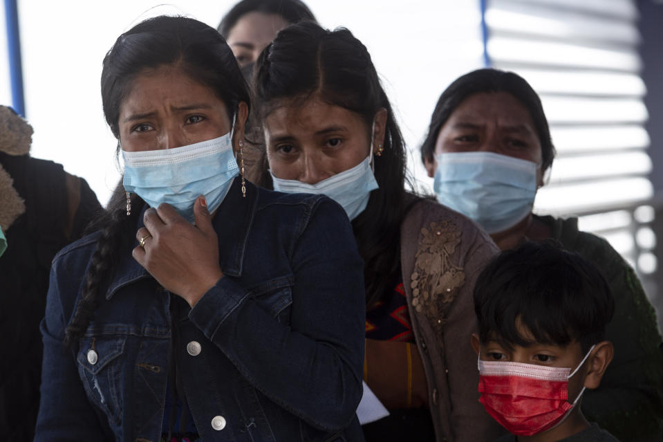 Relatives of Pascual Melvin Guachiac Sipac cry as they watch his coffin arrive to the airport in Guatemala City, Friday, June 15, 2022. The 13-year-old was among a group of migrants who died of heat and dehydration in a trailer-truck abandoned by smugglers on the outskirts of San Antonio, Texas, on June 27. (AP Photo/Oliver de Ros)