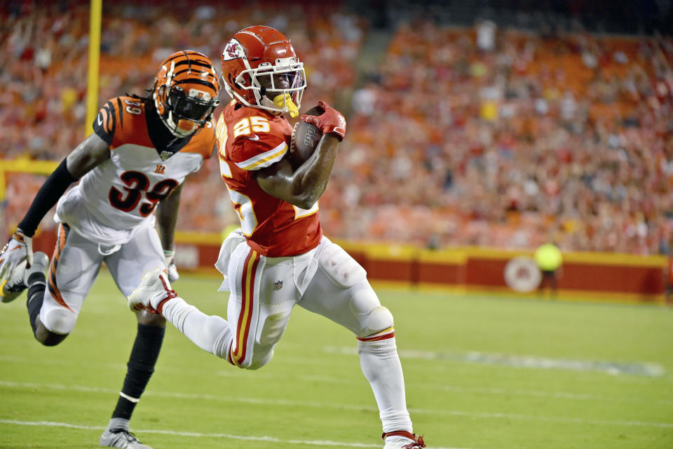 Kansas City Chiefs running back Darwin Thompson (25) runs for a touchdown ahead of Cincinnati Bengals defensive back Tony Lippett (39) during the second half of an NFL preseason football game in Kansas City, Mo., Saturday, Aug. 10, 2019. (AP Photo/Ed Zurga)