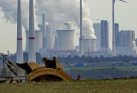 Steam comes out of the chimneys of the coal-fired power station Neurath near the Garzweiler open-cast coal mine in Luetzerath, Germany, Monday, Oct.25, 2021. The climate change conference COP26 will start next Sunday in Glasgow, Scotland. (AP Photo/Michael Probst)