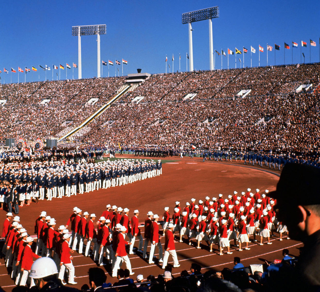 (FILES) Photo taken 10 October 1964 shows the opening ceremony of Tokyo Olympic Games at Tokyo's national stadium. Tokyo is making a head start bidding for the 2016 Summer Olympics, with its nationalist leader hoping to restore some of the glory of Japan's first Games after Beijing showcases China's rise in 2008. Japan, which is emerging from a decade-long economic slump, has become the first nation to formally inform the International Olympic Committee (IOC) of its candidacy for the 2016 Games which won't be decided until mid-2009.    AFP PHOTO/JIJI PRESS (Photo by STR / JIJI PRESS FILES / AFP) / Japan OUT        (Photo credit should read STR/AFP via Getty Images)