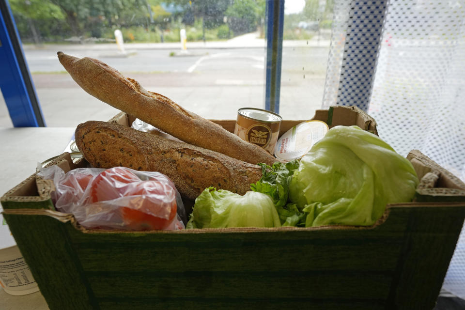 A box of food sits at the Community Food Hub in Hackney, London, Thursday, June 13, 2024. Since calling a general election, British Prime Minister Rishi Sunak has been at pains to repeat a key message on the campaign trail: The economy is turning a corner, inflation is down, and things are looking up. That’s not the reality for millions across the U.K. still feeling the squeeze from high food, energy and housing prices. (AP Photo/Kin Cheung)