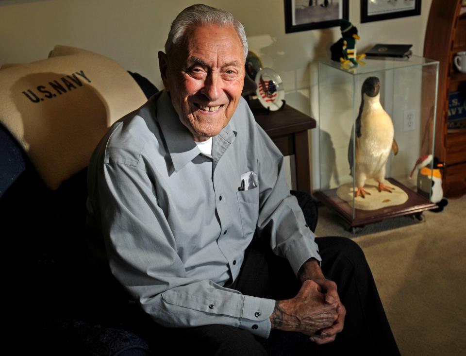 In this May 2011 photo, Robert Johnson sits at his home with a stuffed penguin from an Antarctic expedition. He took part in an expedition to Antarctica with Admiral Richard Byrd in 1939 and then later trips to the Arctic and back to Antarctica.