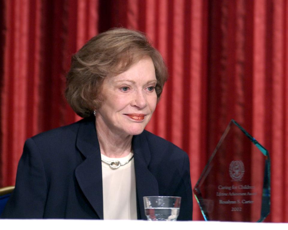 Rosalynn Carter sits next to her Caring for Children lifetime achievement award during a ceremony in Washington on July 12, 2002. She was honored for her contribution to improving the quality of life for vulnerable children and their families.