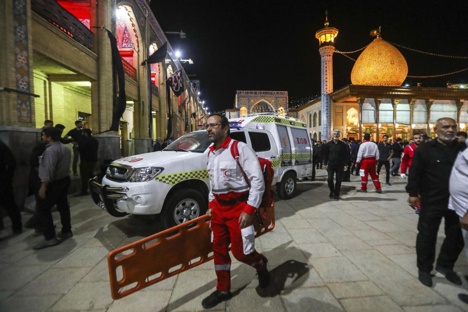 In this photo provided by Iranian Students' News Agency, ISNA, a medic carries a stretcher at Shah Cheragh shrine, the scene of a gunman attack in the southern city of Shiraz, Iran, Sunday, Aug. 13, 2023. A gunman opened fire Sunday night at a prominent shrine in southern Iran, wounding at least four people, authorities said. Information on the attack at Shah Cheragh remained unclear immediately after the shooting, with state media and semiofficial news agencies offering differing details. (Mohammadreza Dehdari, ISNA via AP)