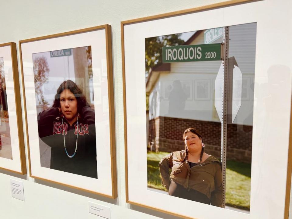 Some examples of the photography featured in the exhibit where participants are posed in front of real street signs in the area, whose names correlate to their nation. 