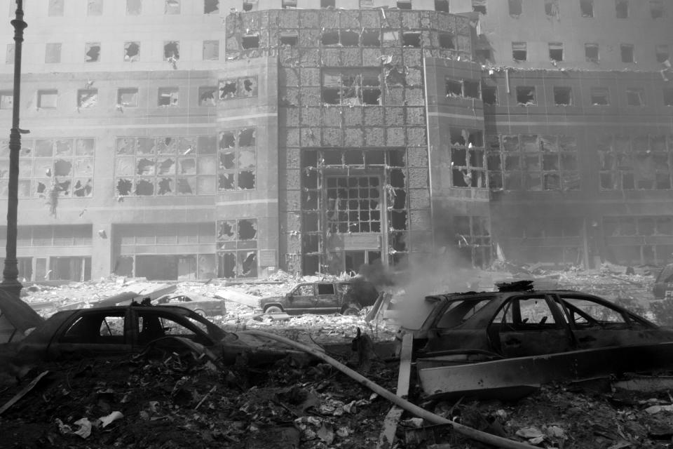 <p>Rubble-buried cars and a destroyed building in the aftermath of the Sept. 11 attacks in 2001. (Photo: Shawn Baldwin/AP) </p>