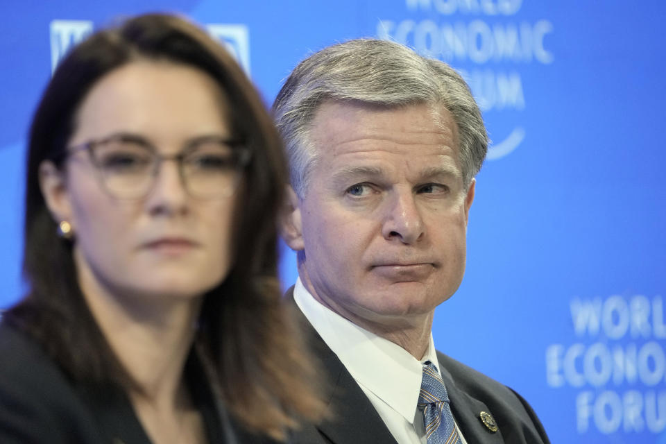 Ukraine Vice-Prime Minister Yulia Svyrydenko, left, is watched by FBI Director Christopher Wray, right, on a podium at the World Economic Forum in Davos, Switzerland Thursday, Jan. 19, 2023. The annual meeting of the World Economic Forum is taking place in Davos from Jan. 16 until Jan. 20, 2023. (AP Photo/Markus Schreiber)