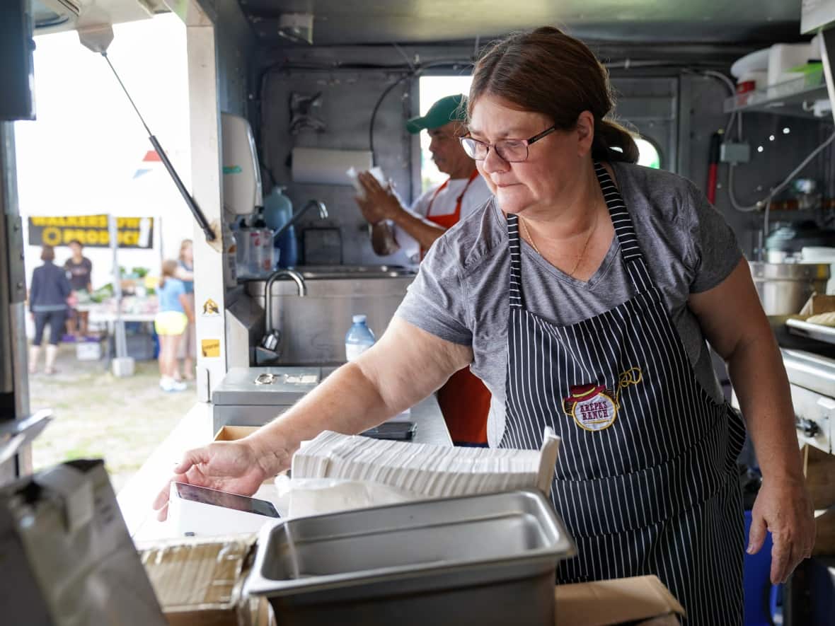 Carolina De La Torre, co-owner of the Arepas Ranch food truck, says the soaring costs of food, gas and propane has caused problems for her business.  (Photo by Axel Tardieu - image credit)