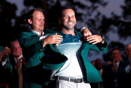 FILE PHOTO: Sergio Garcia of Spain smiles as he is presented the green jacket by last year's champion, Danny Willett of England, after winning the 2017 Masters golf tournament in a playoff at Augusta National Golf Club in Augusta, Georgia, U.S., April 9, 2017. REUTERS/Mike Segar/File Photo