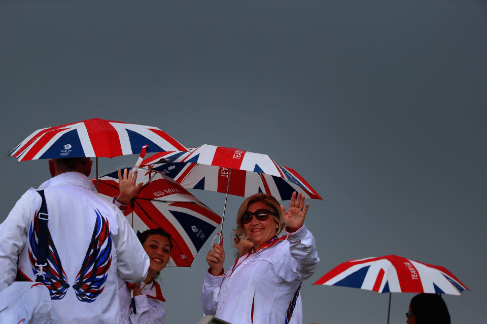 LONDON, ENGLAND - JULY 29: Volunteers hold Union Jack umbrellas in the Olympic Park on Day 2 of the London 2012 Olympic Games on July 29, 2012 in London, England. (Photo by Jeff J Mitchell/Getty Images)