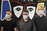 Volunteers Georgy Smirnov, Dmitry Tolkachev and Sergey Semenikhin pose for a photo after their joint news conference at Sechenov University in Moscow, Russia, Monday, July 20, 2020. Russia is boasting that it’s about to be the first country to approve a COVID-19 vaccine, but scientists worldwide are sounding the alarm that the headlong rush could backfire. (Alexander Avilov/ Moscow News Agency via AP)