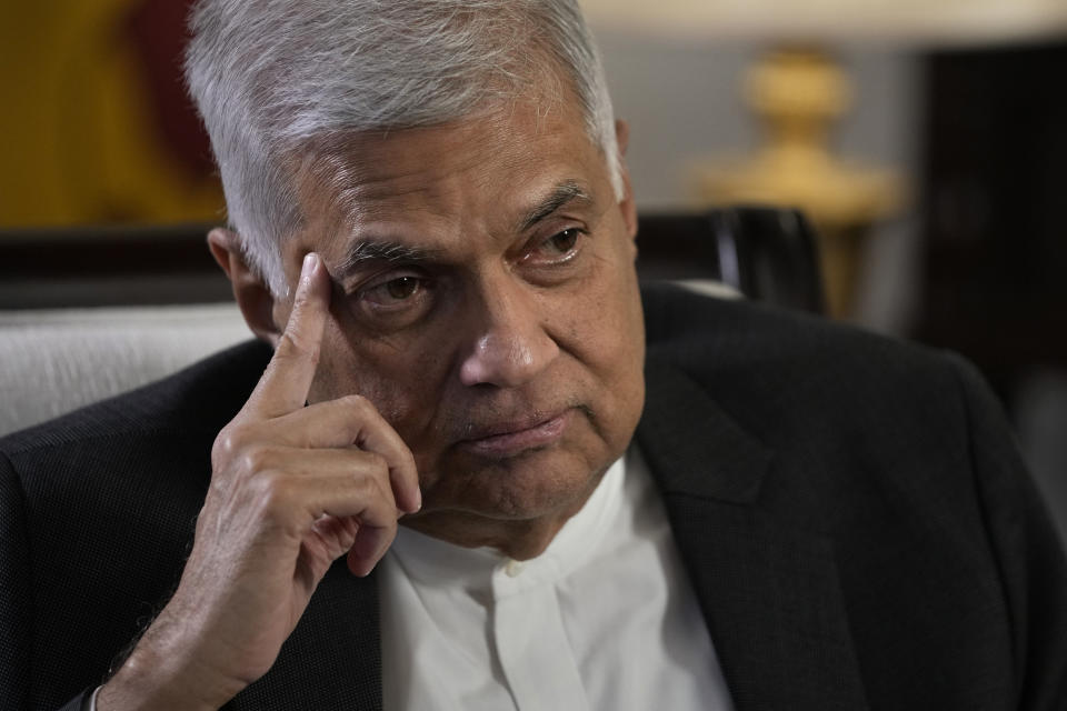 FILE - Sri Lanka's new Prime Minister Ranil Wickremesinghe gestures during an interview with The Associated Press in Colombo, Sri Lanka, on June 11, 2022. On Friday, July 22, now Sri Lanka's new president, Wickremesinghe, appointed a classmate and ally of ousted President Gotabaya Rajapaksa to be his prime minister and partner in rescuing the country from its predicament. The question is whether they can muster the political heft and enough support from a public fed up with shortages of food, fuel and medicine to get the job done. (AP Photo/Eranga Jayawardena, File)