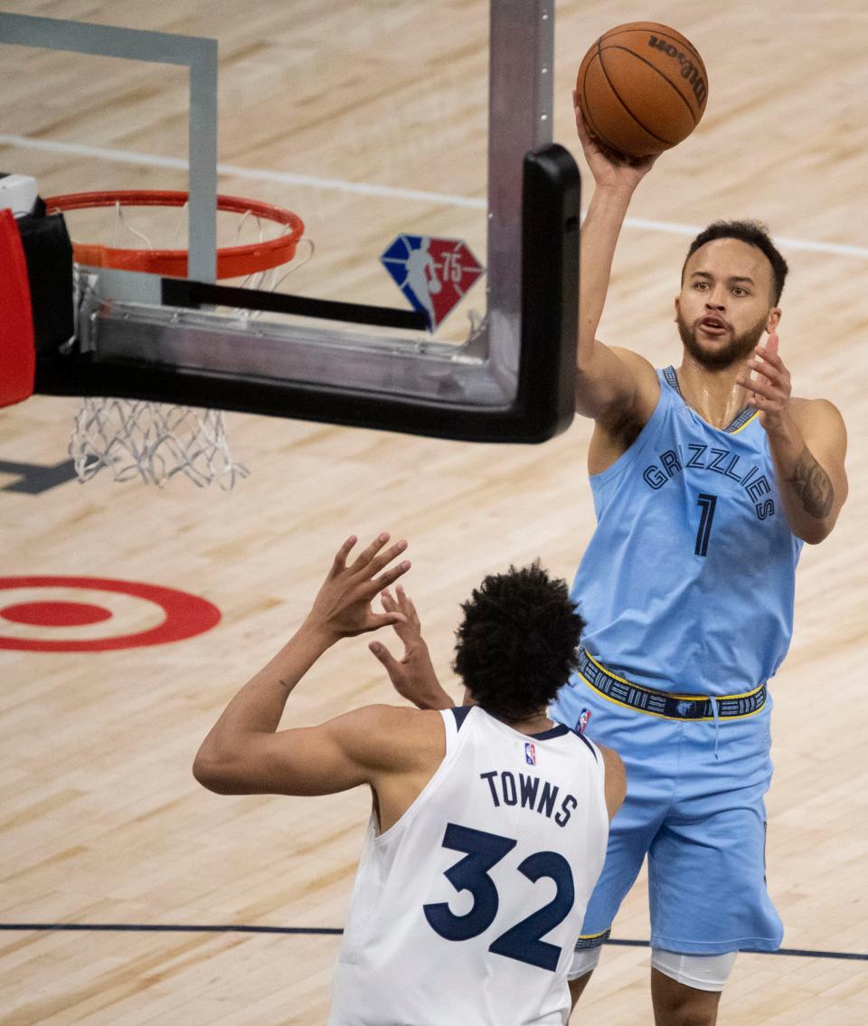 Minnesota Timberwolves center Karl-Anthony Towns (32) guards Memphis Grizzlies forward Kyle Anderson (1) as he shoots the ball during the first half of game four of the first round for the 2022 NBA playoffs Saturday, April 23, 2022, at Target Center in Minneapolis, Minn. The Minnesota Timberwolves defeated the Memphis Grizzlies 119-118.