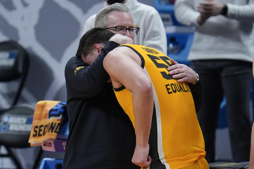 Iowa head coach Fran McCaffery hugs Luka Garza (55) during the second half of a men's college basketball game against Oregon in the second round of the NCAA tournament at Bankers Life Fieldhouse in Indianapolis, Monday, March 22, 2021. (AP Photo/Paul Sancya)