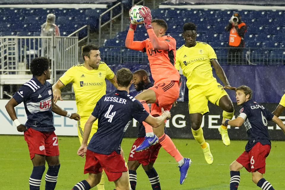 New England Revolution goalkeeper Matt Turner, center, grabs a shot in front of the goal during the first half of an MLS soccer match against Nashville SC Friday, Oct. 23, 2020, in Nashville, Tenn. (AP Photo/Mark Humphrey)