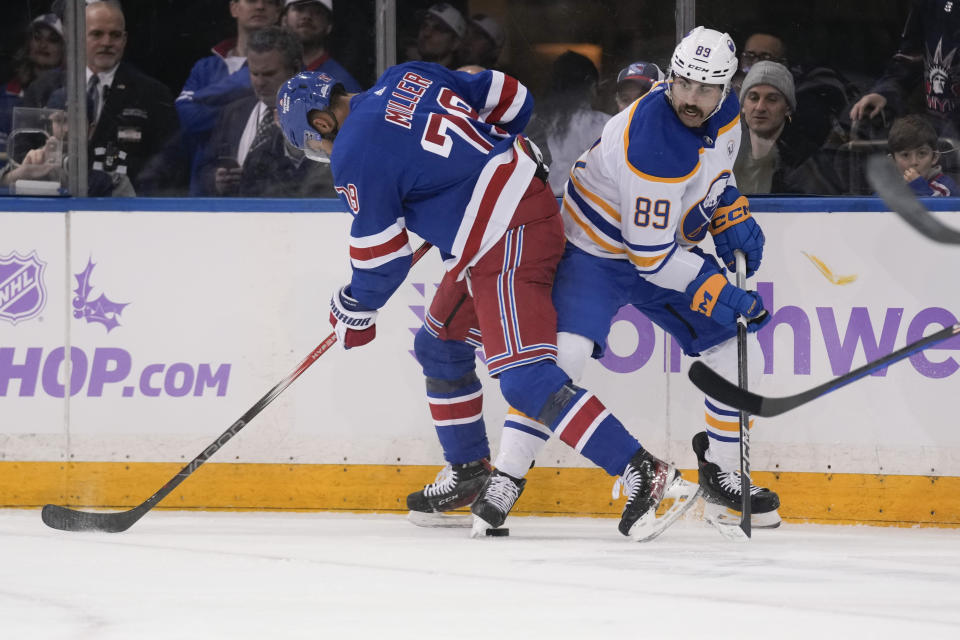 Buffalo Sabres' Alex Tuch, right, and New York Rangers' K'Andre Miller, left, compete for the puck during the first period of an NHL hockey game, Monday, Nov. 27, 2023, in New York. (AP Photo/Seth Wenig)