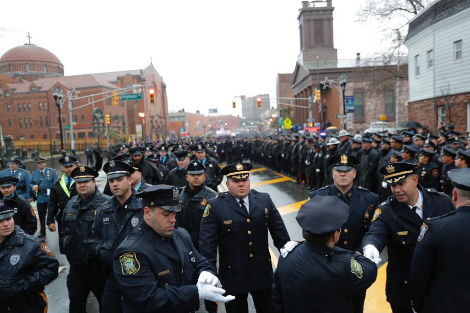 Police officers and other first responders gather before the funeral of Jersey City Police Detective Joseph Seals in Jersey City, N.J., Tuesday, Dec. 17, 2019. Funeral services for Seals are scheduled for Tuesday morning. The 40-year-old married father of five was killed in a confrontation a week ago with two attackers who then drove to a kosher market and killed three people inside before dying in a lengthy shootout with police. (AP Photo/Seth Wenig)