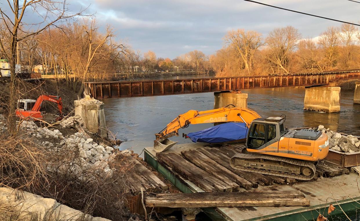 Contractors work on converting the old railroad bridge over the St. Joseph River, just north of Angela Boulevard, into a pedestrian bridge for the Coal Line Trail in South Bend on Jan. 8, 2023. A section of it to the left will be replaced.