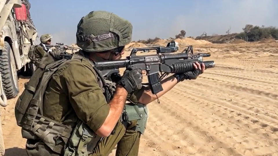 An IDF soldier points his gun in northern Gaza. (Raf Sanchez / NBC News)