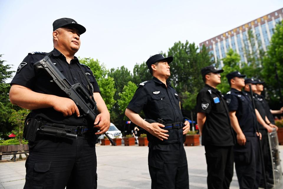 Armed police stand by in front of a college entrance exam site in Qingdao, Shandong province, China, June 7, 2023. The 2023 National college entrance examination, or gaokao, officially kicked off on Tuesday, with 12.91 million students expected to go to the exam halls across the country, a record high.