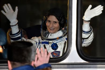 International Space Station (ISS) crew Samantha Cristoforetti of Italy waves from a bus at the Baikonur cosmodrome November 23, 2014. REUTERS/Kirill Kudryavtsev/Pool