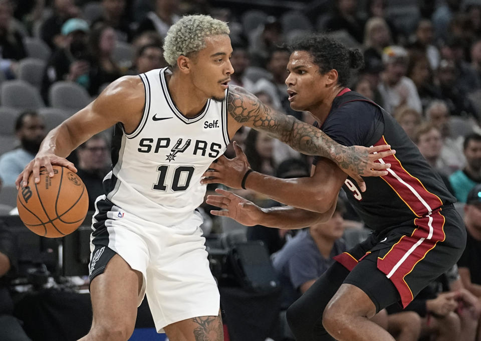 San Antonio Spurs forward Jeremy Sochan (10) drives against Miami Heat guard Dru Smith (9) during the first half of a preseason NBA basketball game in San Antonio, Friday, Oct. 13, 2023. (AP Photo/Eric Gay)