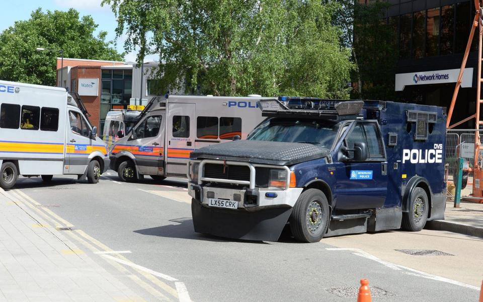 Police vehicles block a roadway outside Wembley Stadium to protect fans - Credit: John Stillwell/PA