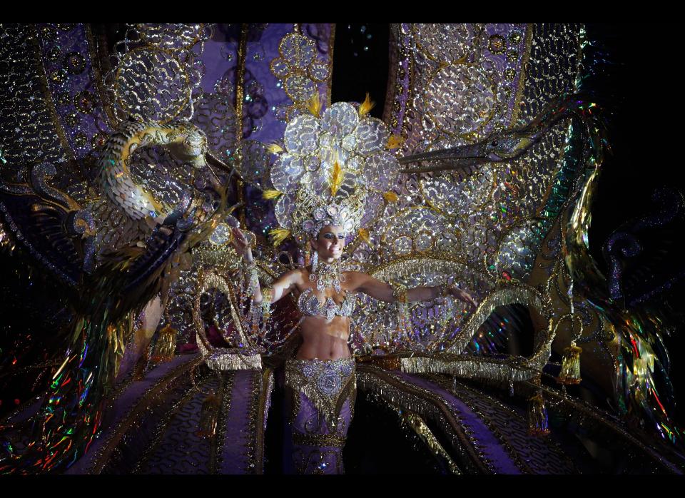 A nomine for Queen of the Santa Cruz carnival shows off her outfit under the watchful eyes of the jury at Santa Cruz de Tenerife on the Spanish Canary island of Tenerife, February 15, 2012. (DESIREE MARTIN/AFP/Getty Images)