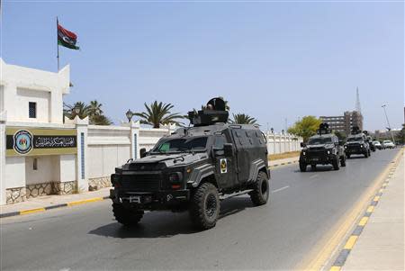 Libyan Security forces vehicles patrol to secure the area where Libya’s parliament members are meeting, at the Crown Prince's Palace in Tripoli May 25, 2014. REUTERS/Ahmed Jadallah