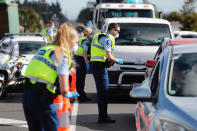 Police man a road block on the outskirts of Auckland as New Zealand's largest city moved to COVID-19 Alert Level 3, Wednesday, Aug. 12, 2020. Health authorities in New Zealand were scrambling to trace the source of a new outbreak as the nation’s largest city went back into lockdown. (Dean Purcell/New Zealand Herald via AP)