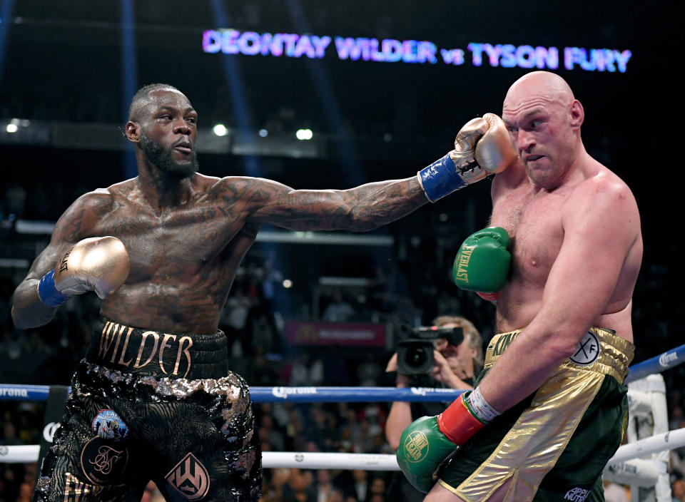 LOS ANGELES, CA - DECEMBER 01:  Deontay Wilder punches Tyson Fury in the ninth round fighting to a draw during the WBC Heavyweight Championship at Staples Center on December 1, 2018 in Los Angeles, California.  (Photo by Harry How/Getty Images)