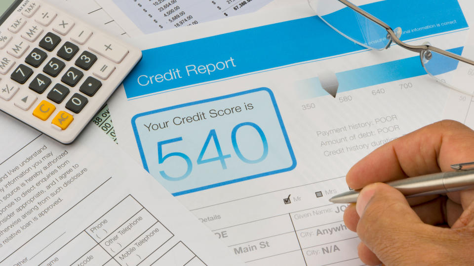 Credit report form on a desk with other paperwork.