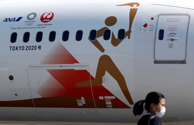 FILE PHOTO: 'Tokyo 2020 Go' aircraft leaves Tokyo's Haneda airport for Greece to collect the Olympic Flame, ahead of torch relay