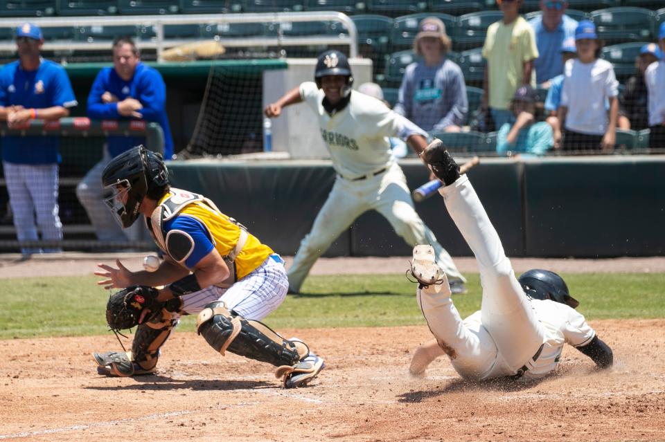 Sal Stewart of Westminster Christian slides safely into home behind John Carroll Catholic catcher Gabe Morin in the FHSAA Class 3A State Baseball semifinals on Monday, May 24, 2021, at CenturyLinks Sports Complex in Fort Myers. Westminster won 3-0. 