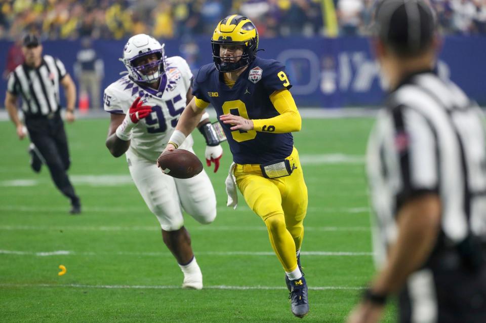 Michigan quarterback J.J. McCarthy (9) runs the ball in the first quarter of the Fiesta Bowl on Saturday, Dec. 31 at State Farm Stadium in Glendale, Ariz.