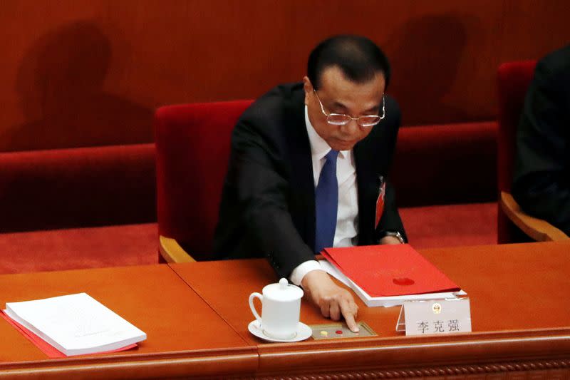 Chinese Premier Li Keqiang casts his vote on the national security legislation for Hong Kong Special Administrative Region at the closing session of NPC in Beijing