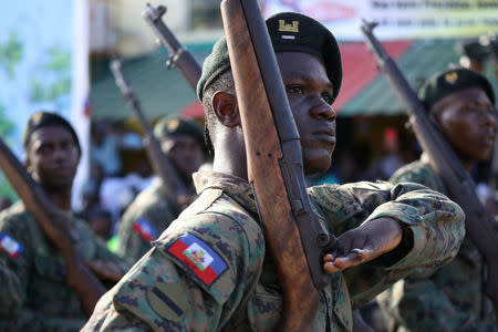 Members of the Haitian Armed Forces (FAD'H) salute as they parade in the streets of Cap-Haitien, Haiti, November 18, 2017. REUTERS/Andres Martinez Casares