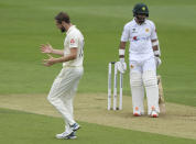 England's Chris Woakes, left, reacts after teammate Rory Burns dropped a catch of Pakistan's Abid Ali, right, during the first day of the second cricket Test match between England and Pakistan, at the Ageas Bowl in Southampton, England, Thursday, Aug. 13, 2020. (Stu Forster/Pool via AP)