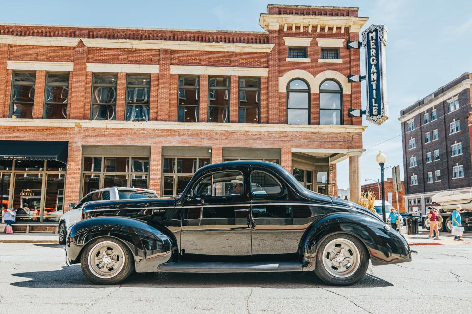 A classic car passes by the Mercantile in Pawhuska.