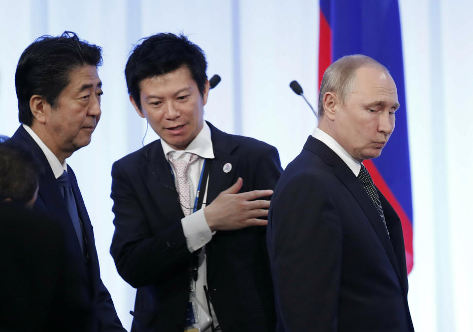 Russian President Vladimir Putin, right, and Japanese Prime Minister Shinzo Abe, left, enter a venue for a signing ceremony and their news conference on the sidelines of the G-20 leaders summit in Osaka, western Japan, June 29, 2019. (Kim Kyung-Hoon/Pool Photo via AP)