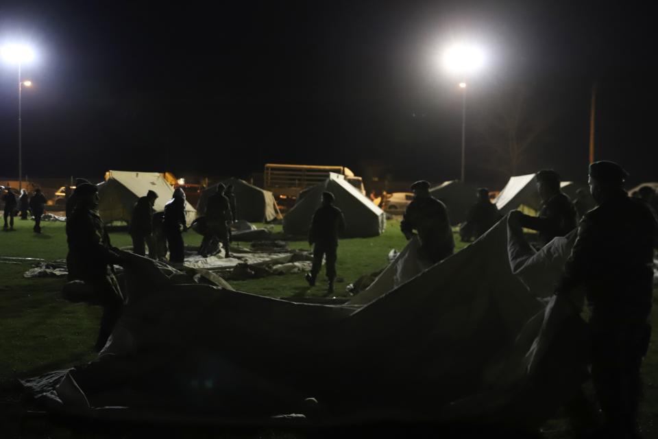 Greek Army set up a tent after an earthquake in Damasi village, central Greece, Wednesday, March 3, 2021. An earthquake with a preliminary magnitude of at least 6.0 struck central Greece Wednesday and was also felt in neighboring Albania and North Macedonia, and as far as Kosovo and Montenegro. (AP Photo/Vaggelis Kousioras)