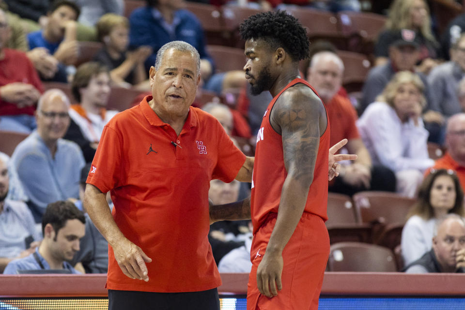 Houston's head coach Kelvin Sampson, left, talks with player Jamal Shead, right, in the second half of an NCAA college basketball game against Utah during the Charleston Classic in Charleston, S.C., Friday, Nov. 17, 2023. (AP Photo/Mic Smith).