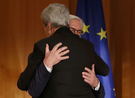 U.S. Secretary of State John Kerry (front) embraces German Foreign Minister Frank-Walter Steinmeier during an award ceremony at the Foreign Ministry in Berlin, Germany, December 5, 2016. REUTERS/Fabrizio Bensch