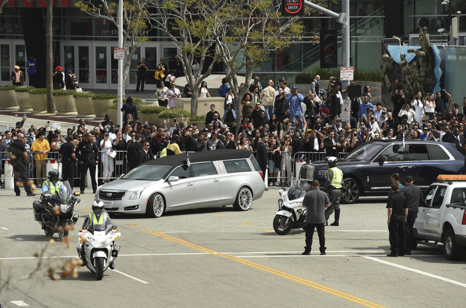 A silver hearse carrying the body of Nipsey Hussle, whose given name was Ermias Asghedom, leaves Staples Center in a procession following the Celebration of Life memorial service for the late rapper on Thursday, April 11, 2019, at the Staples Center in Los Angeles. (Photo by Chris Pizzello/Invision/AP)