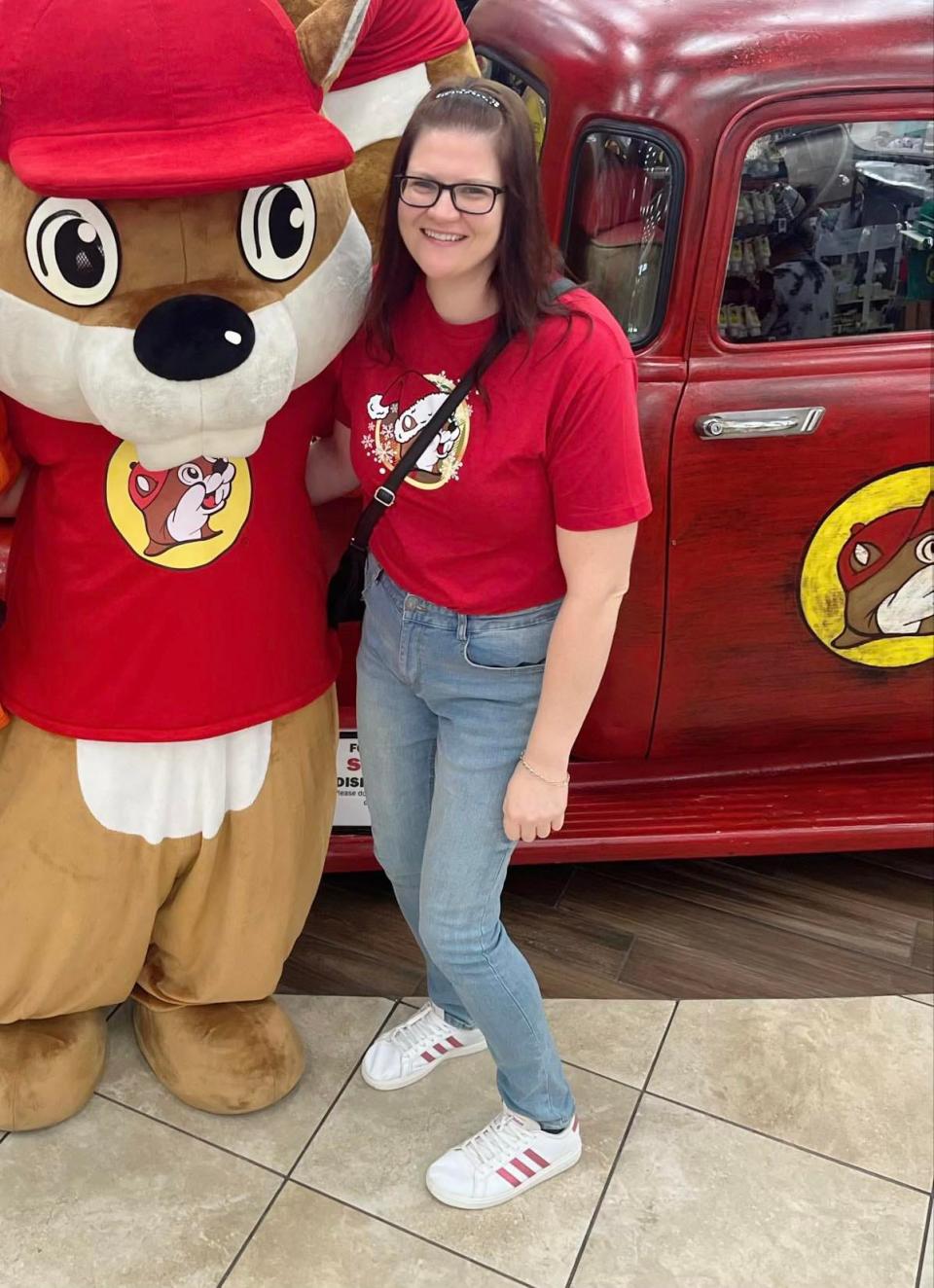 Laura Amy, a communications and marketing employee for Texas Snax, poses with a Buc-ee's mascot in Texas. Texas Snax is an online reseller of Buc-ee's merchandise. The Dallas, Texas-based company is not affiliated with Buc-ee's.