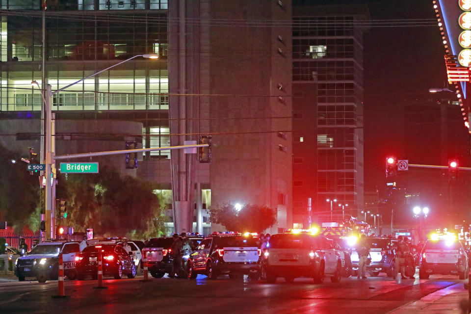 Police and rescue workers swarm the intersection outside Lloyd D. George Federal Courthouse, where shots were fired late Monday, June 1, 2020, in downtown Las Vegas. Police were present for a protest over the death of George Floyd, a Minneapolis man who died in police custody on Memorial Day. (AP Photo/Ronda Churchill)